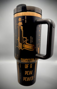 Black travel mug with gold text and design on a gray background