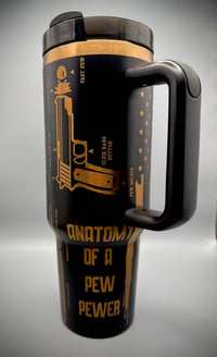 Black travel mug with gold text and design on a gray background